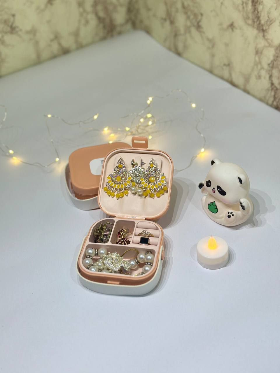 Open JewelCase organizer with earrings, rings and pearls arranged neatly inside